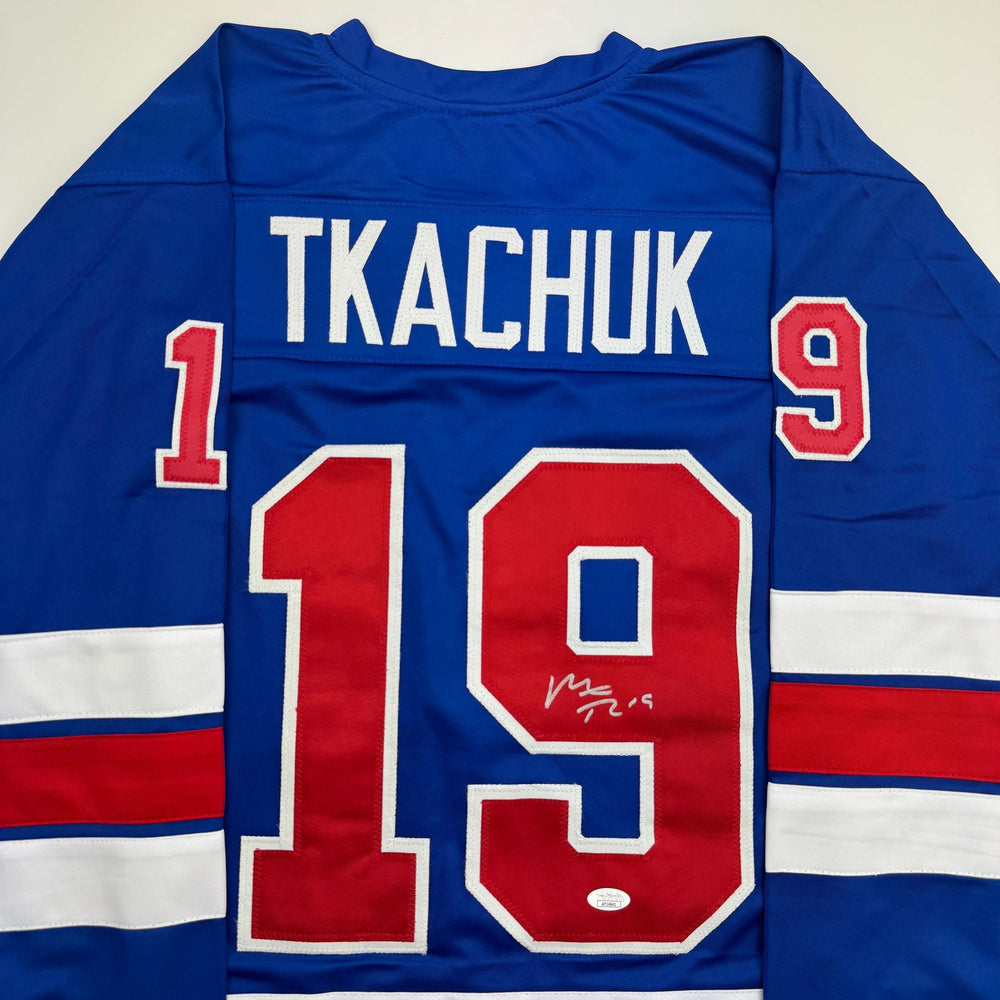 Autographed/Signed Matthew Tkachuk USA United States 2026 Olympics Gold Medal Blue Hockey Jersey JSA COA