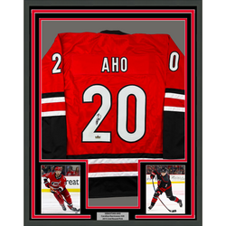Framed Facsimile Autographed Sebastian Aho 35x39 Carolina Red Reprint Laser Auto Hockey Jersey (ONLINE ORDER ONLY)